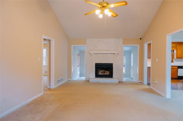 unfurnished living room featuring ceiling fan, high vaulted ceiling, light carpet, and a fireplace