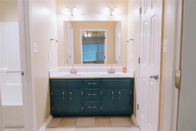 bathroom with ceiling fan, tile patterned floors, vanity, and a tub to relax in