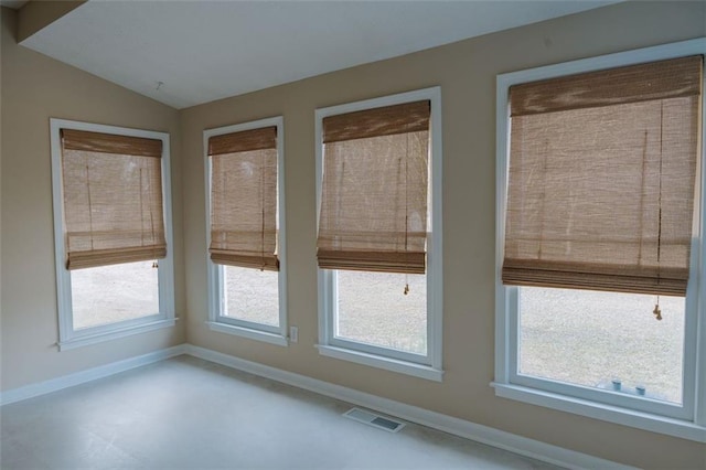 spare room featuring lofted ceiling