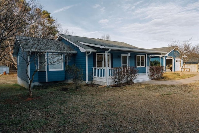 view of front facade with a garage, a front lawn, and covered porch