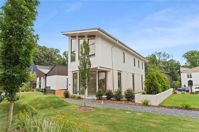 rear view of property with a lawn