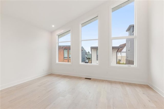 spare room featuring light hardwood / wood-style flooring