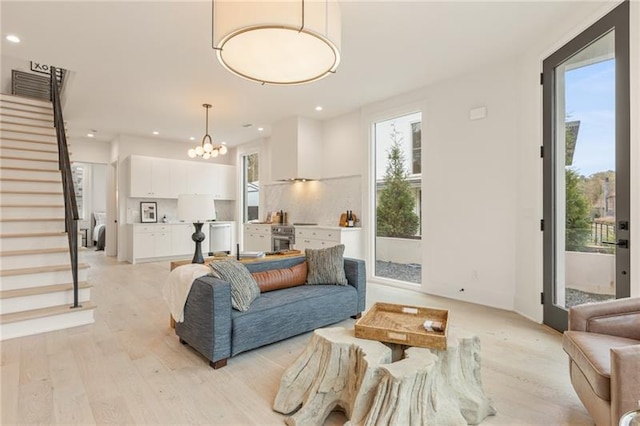 living room featuring light hardwood / wood-style floors and an inviting chandelier