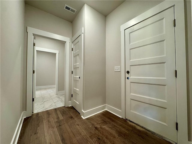 entryway with visible vents, dark wood finished floors, and baseboards