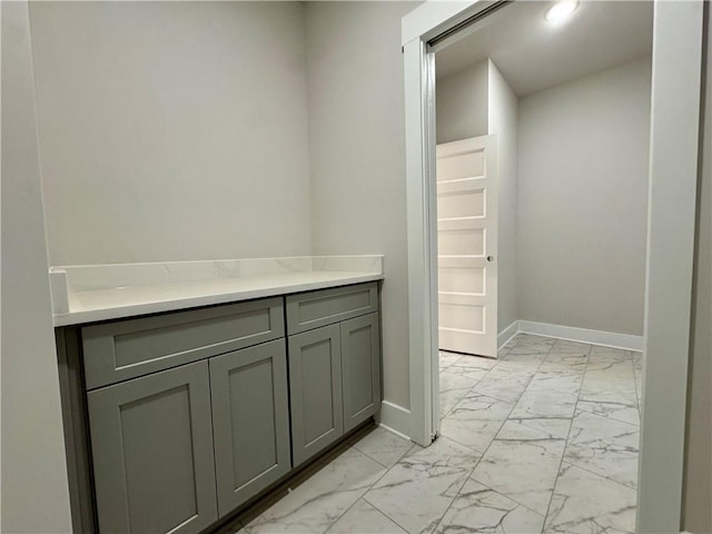 bathroom with marble finish floor and baseboards