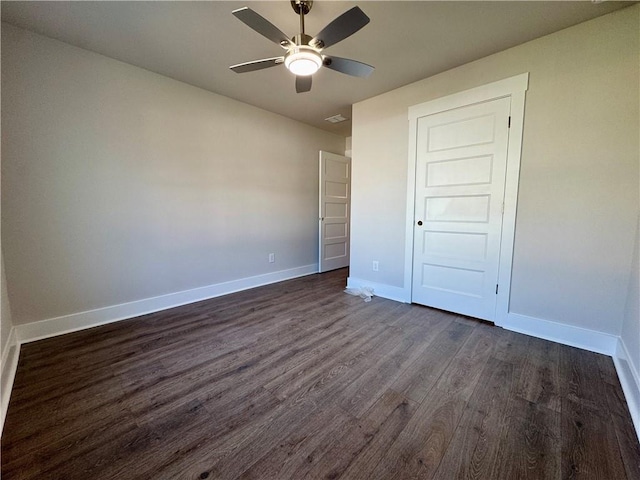 unfurnished bedroom featuring dark wood-style floors, ceiling fan, and baseboards