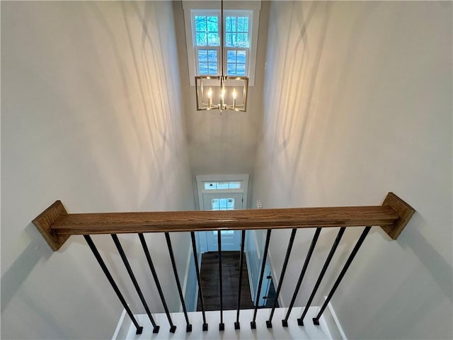 staircase featuring a notable chandelier