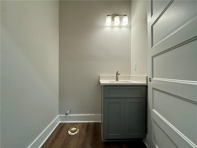 bathroom with vanity, baseboards, and wood finished floors