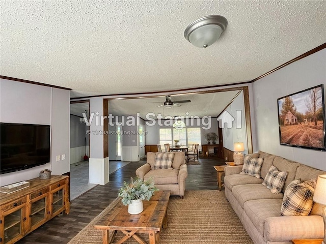 living room with a textured ceiling, dark hardwood / wood-style floors, ceiling fan, and crown molding