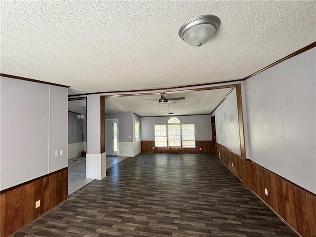 empty room featuring ceiling fan, ornamental molding, and a textured ceiling