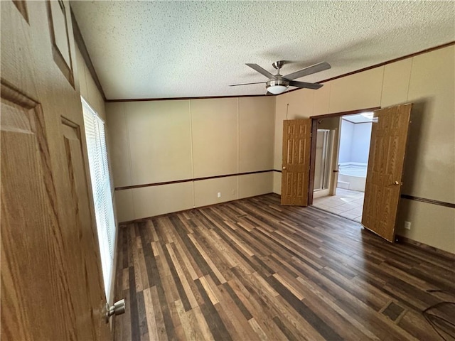 empty room with a textured ceiling, dark hardwood / wood-style flooring, and ceiling fan