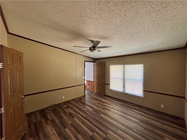 unfurnished bedroom featuring ceiling fan, crown molding, a textured ceiling, and dark wood-type flooring