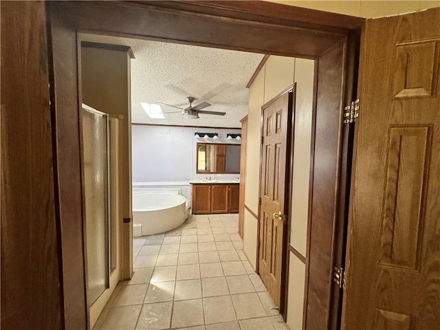 bathroom with vanity, a textured ceiling, ceiling fan, independent shower and bath, and tile patterned flooring