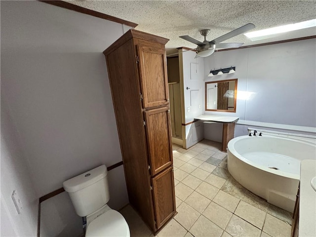 bathroom featuring tile patterned floors, vanity, ceiling fan, toilet, and a tub