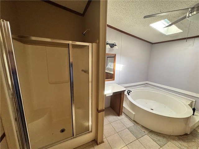 bathroom featuring separate shower and tub, a skylight, vanity, and a textured ceiling