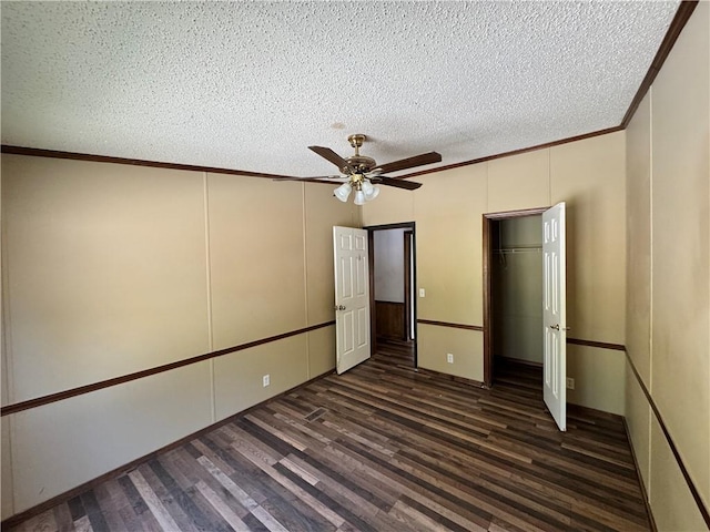 unfurnished bedroom with ceiling fan, dark hardwood / wood-style flooring, and ornamental molding