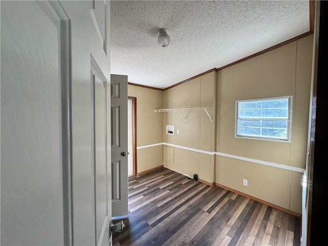 laundry area with a textured ceiling, ornamental molding, dark wood-type flooring, and hookup for a washing machine