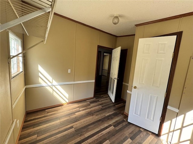 unfurnished room featuring dark hardwood / wood-style flooring and a textured ceiling