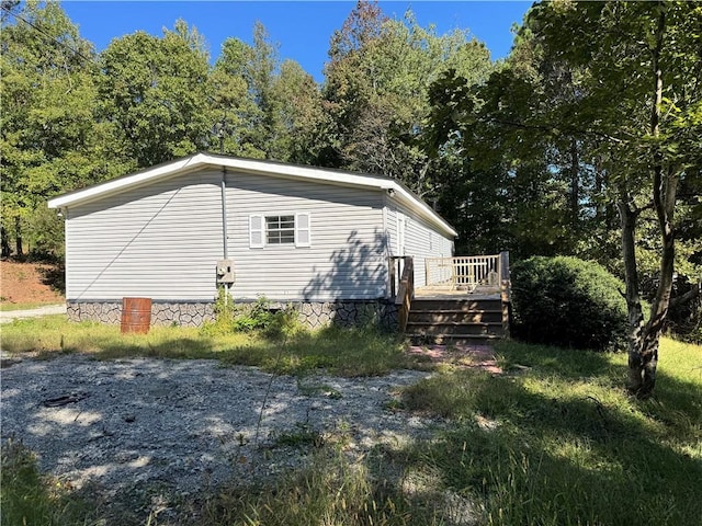 view of side of property featuring a wooden deck