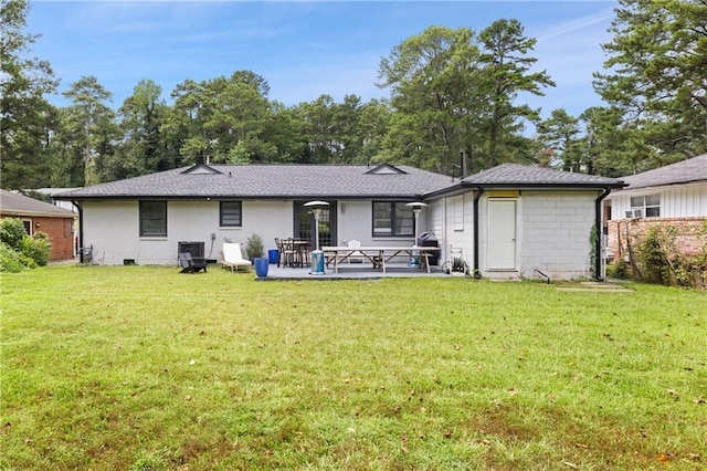 back of property with a patio and a lawn