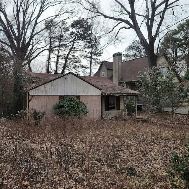 view of side of property with a chimney