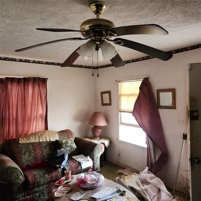 unfurnished living room with a textured ceiling and a ceiling fan