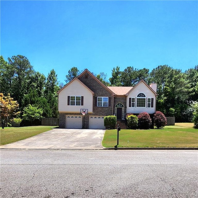 view of front of home featuring a garage and a front yard