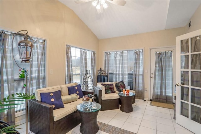 interior space featuring ceiling fan, tile patterned floors, a healthy amount of sunlight, and vaulted ceiling