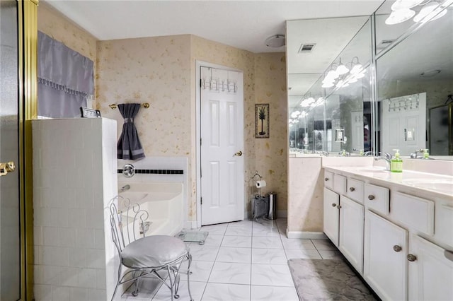 bathroom featuring a tub to relax in and vanity