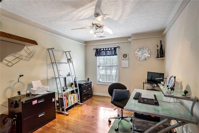 office featuring ceiling fan, ornamental molding, a textured ceiling, and light hardwood / wood-style flooring