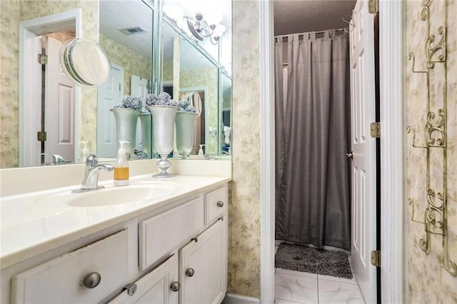 bathroom with a textured ceiling and vanity