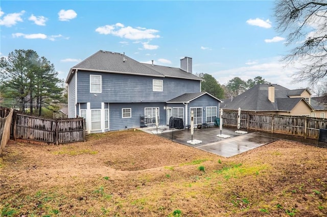 back of house with a patio