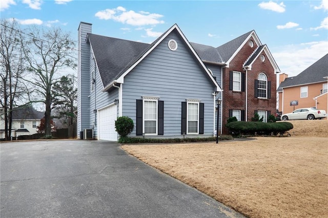 view of property with a garage and central AC