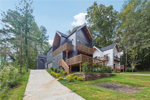 exterior space featuring a garage, a yard, and a deck