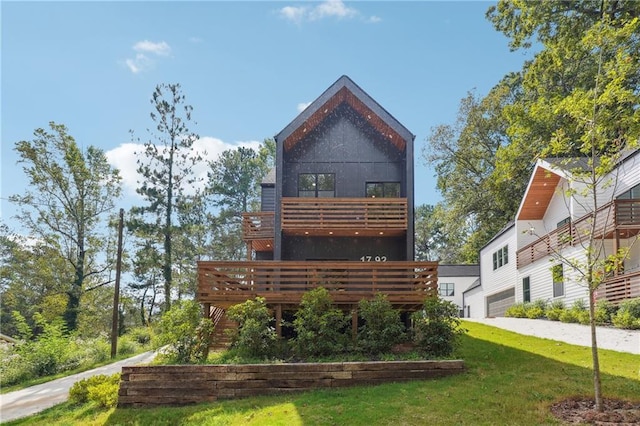 back of property with a wooden deck and a yard