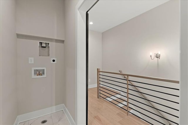 laundry room featuring hookup for an electric dryer, hookup for a washing machine, and light hardwood / wood-style floors