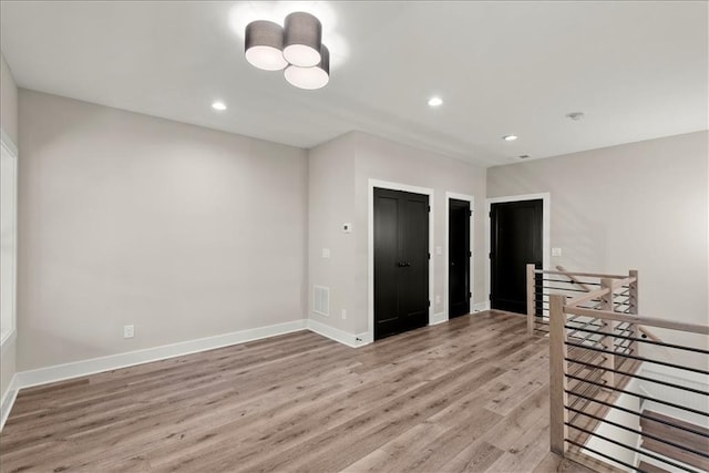 unfurnished room with light hardwood / wood-style floors