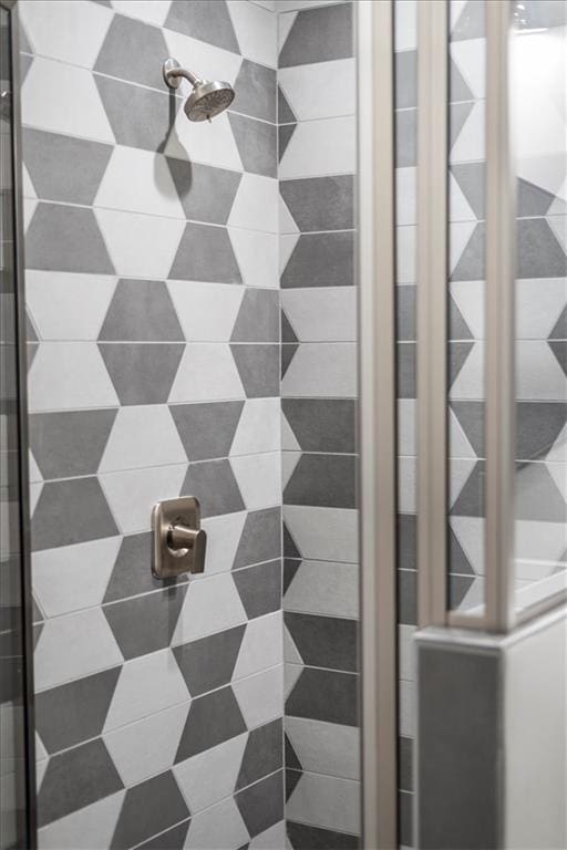 interior details featuring a tile shower