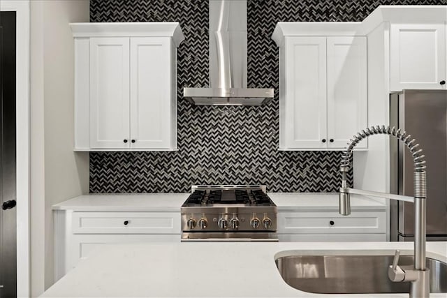 kitchen featuring white cabinets and wall chimney exhaust hood