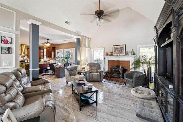 living room with high vaulted ceiling, ceiling fan, and ornate columns