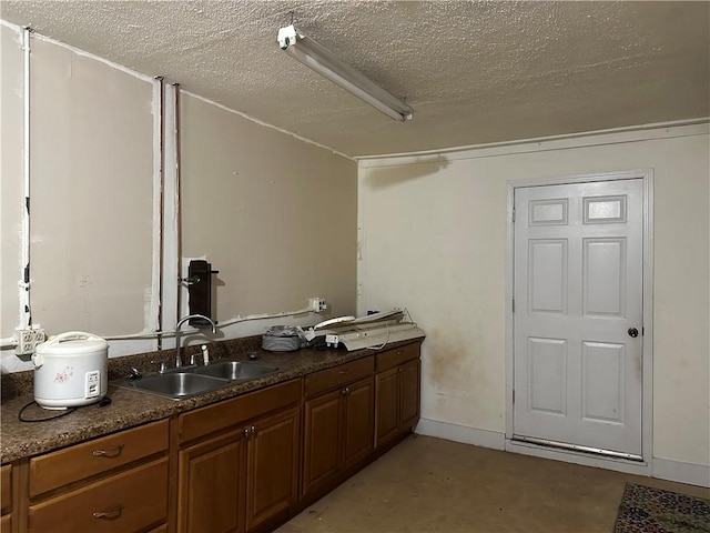 bathroom featuring vanity, concrete floors, and a textured ceiling