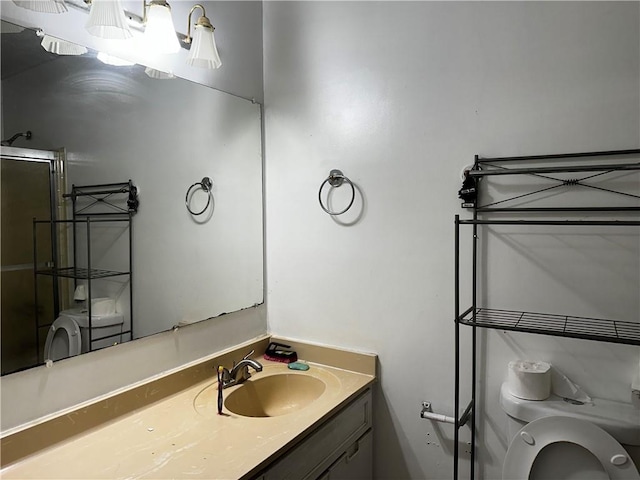 bathroom with vanity, toilet, and an enclosed shower