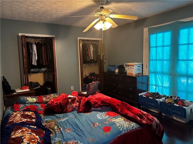 bedroom with a textured ceiling, ceiling fan, and a closet