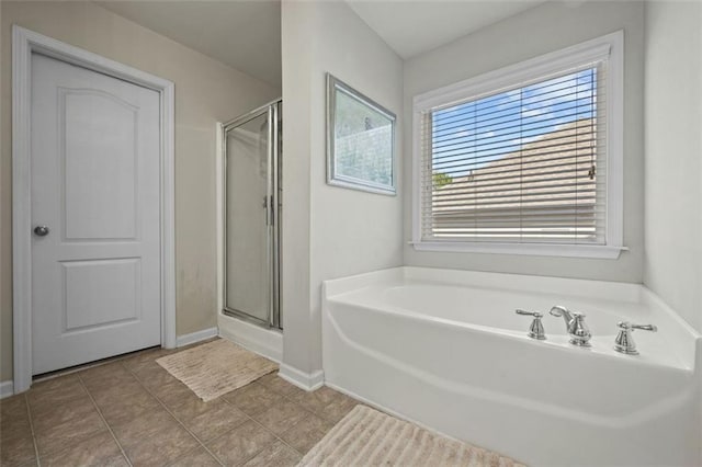 83 Leyland Xing, Dallas, GA 30132 - bathroom featuring a bath, a stall shower, and baseboards