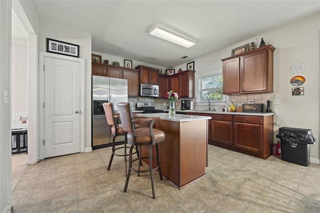 83 Leyland Xing, Dallas, GA 30132 - kitchen with stainless steel appliances, a sink, light countertops, and tasteful backsplash