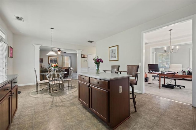 83 Leyland Xing, Dallas, GA 30132 - kitchen featuring decorative columns, a kitchen breakfast bar, an office area, and pendant lighting