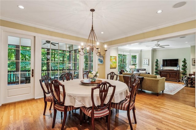 dining space featuring recessed lighting, ceiling fan with notable chandelier, ornamental molding, and light wood finished floors