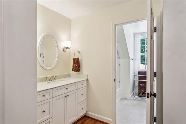 full bathroom featuring vanity, shower / tub combination, and baseboards