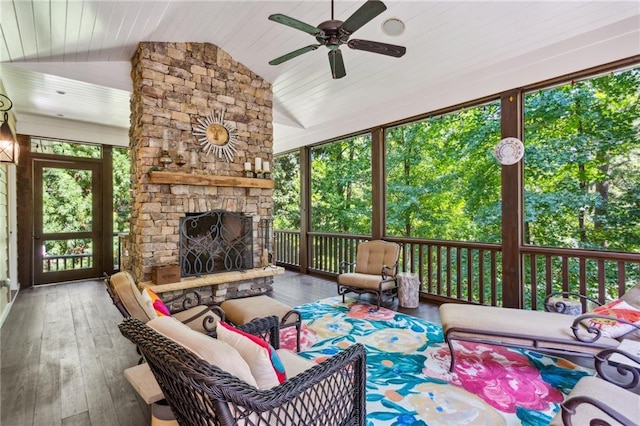 sunroom with wood ceiling, ceiling fan, a fireplace, and vaulted ceiling