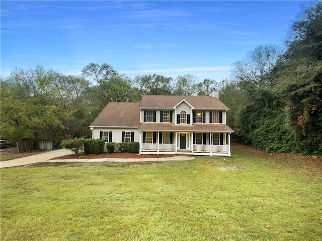 colonial inspired home featuring a porch and a front yard